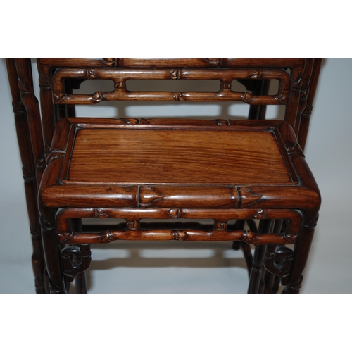 803 - A CHINESE HARDWOOD NEST OF FOUR TABLES