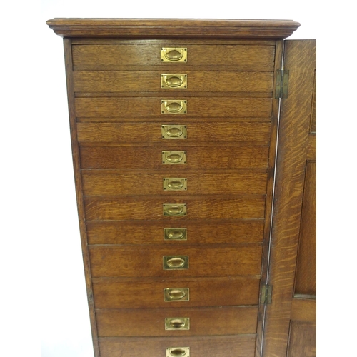 830 - AN EDWARDIAN OAK PANELLED CUPBOARD