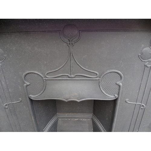 843 - AN ARTS AND CRAFTS CAST IRON FIRE SURROUND