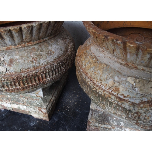 861 - A PAIR OF CAST IRON THISTLE SHAPED GARDEN URNS