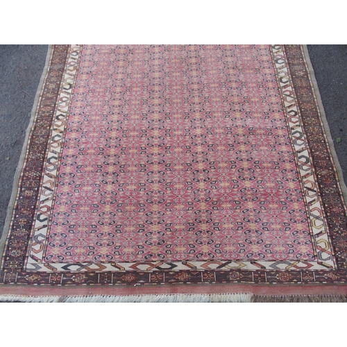 881 - AN EASTERN PINK GROUND RUG