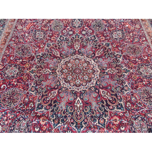 884 - AN EASTERN RED GROUND RUG