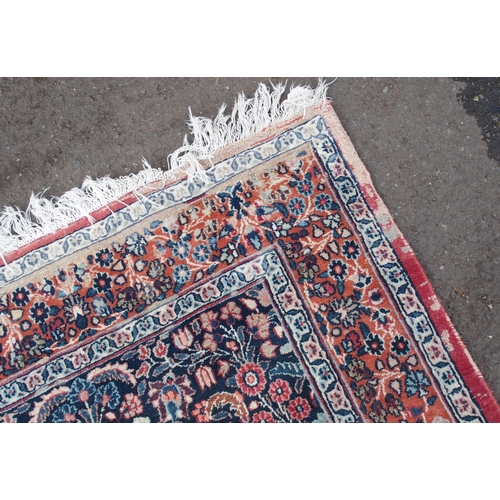 884 - AN EASTERN RED GROUND RUG