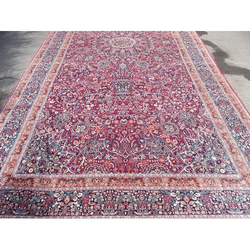 884 - AN EASTERN RED GROUND RUG