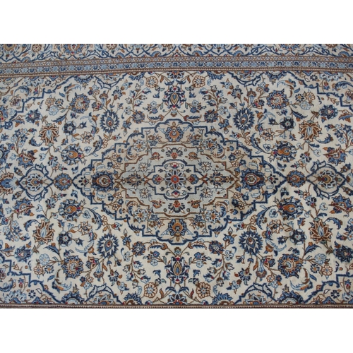 891 - A CREAM GROUND KASHAN RUG