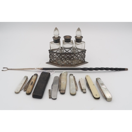 381 - An Edwardian silver and glass three bottle condiment set, comprising three silver collared bottles (... 