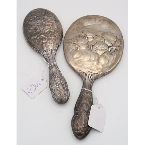 388 - A silver hand mirror with cast decoration of Reynold's Angels, by William Comyns, London 1907, and a... 