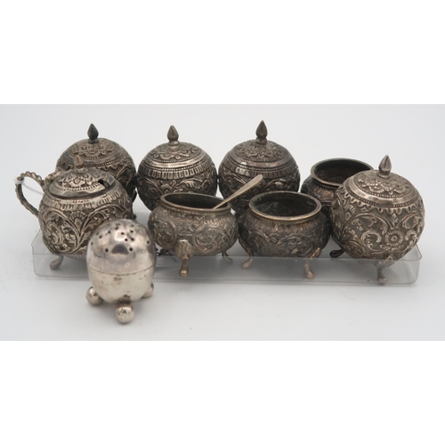 389 - A lot comprising an eastern white metal cruet set comprising 5 globular salts and three open salts, ... 