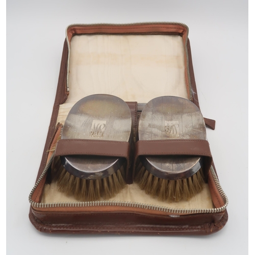 402 - A leather cased silver mounted brush set, with two brushes and a comb, by S. Blanckensee & Son L... 