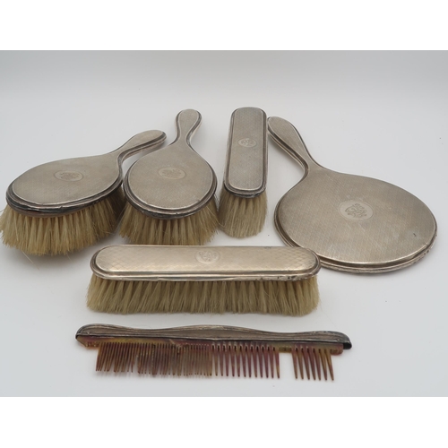 406 - A five piece silver dressing table set, comprising two clothes brushes, two hair brushes a mirror an... 