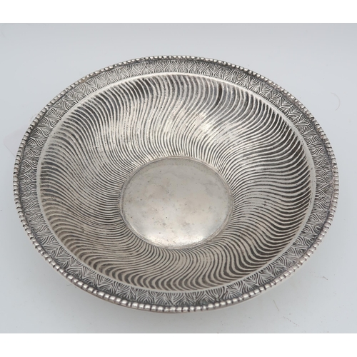 419 - A German silver dish, the cavetto with swirling decoration, with a floral geometric border, 835 stan... 