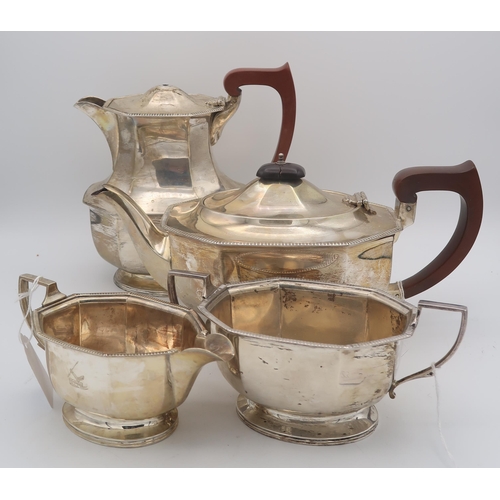 423 - A four piece silver tea service, of faceted form, with engraved crest, by Adie Brothers, Birmingham ... 