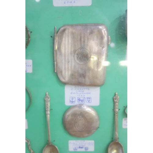 426A - A framed collection of silver and EPNS comprising silver thimbles, a silver spoon, Sheffield 1926, a... 