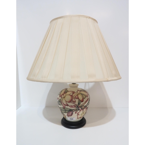 260 - A Moorcroft table lamp with pink flowers on a cream background