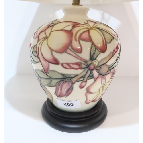 260 - A Moorcroft table lamp with pink flowers on a cream background