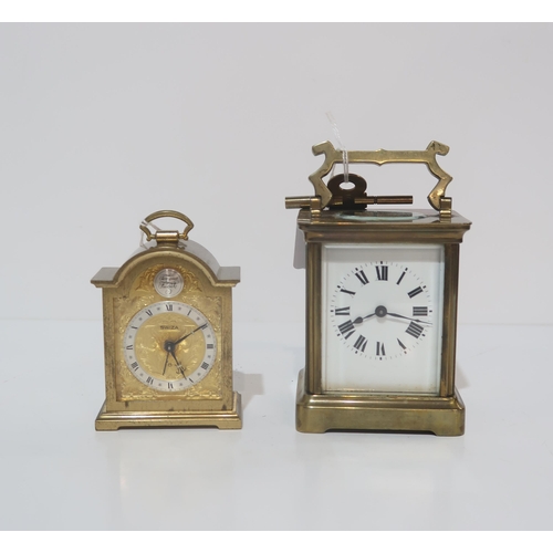 269 - A French brass and glass carriage clock and another clock by Swiza