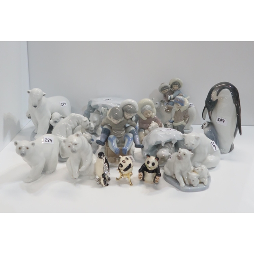 284 - A collection of Lladro polar bear and Eskimo figures together with a penguin and chick figure and th... 