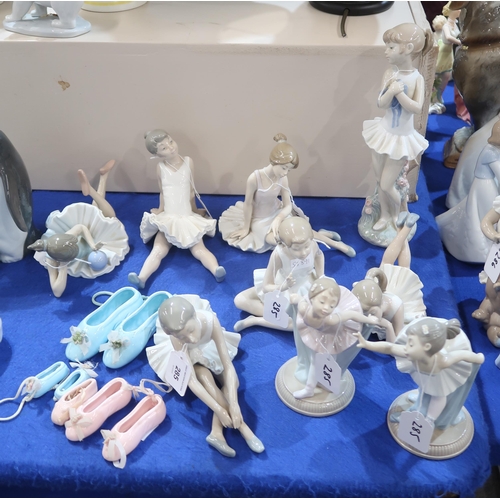 285 - A collection of Nao ballerina figures and ceramic ballet shoes