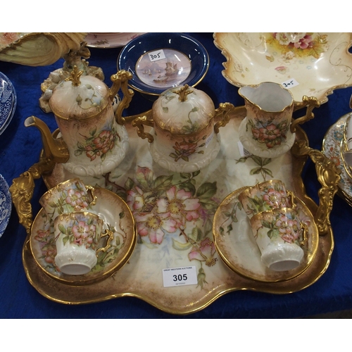 305 - A continental porcelain coffee set on tray, decorated with pink blossom flowers, a Nautilus shell sh... 