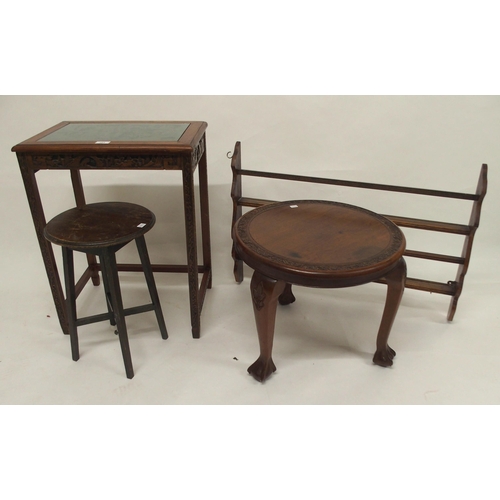 103 - A 20th century Chinese hardwood occasional table with extensively carved top depicting village scene... 