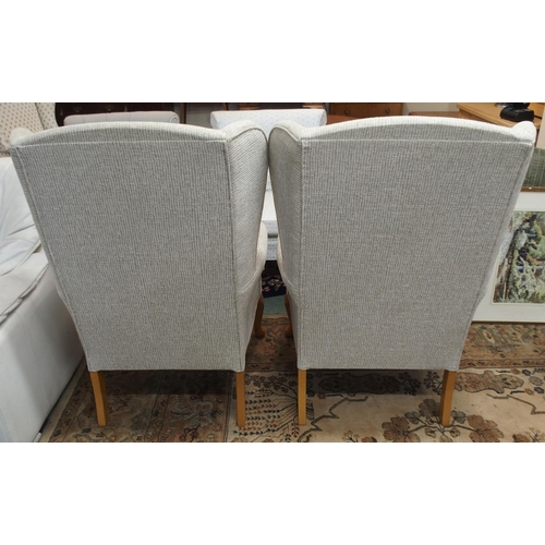 114 - A pair of contemporary wing back armchairs with light grey upholstery on cabriole supports (2)