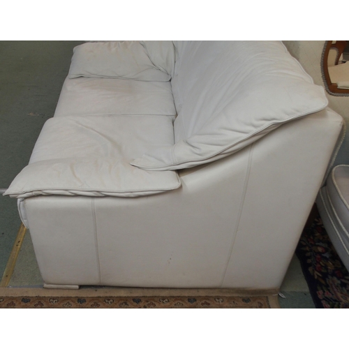 115 - A 20th century white leather upholstered two seater sofa, 85cm high x 140cm wide x 95cm deep