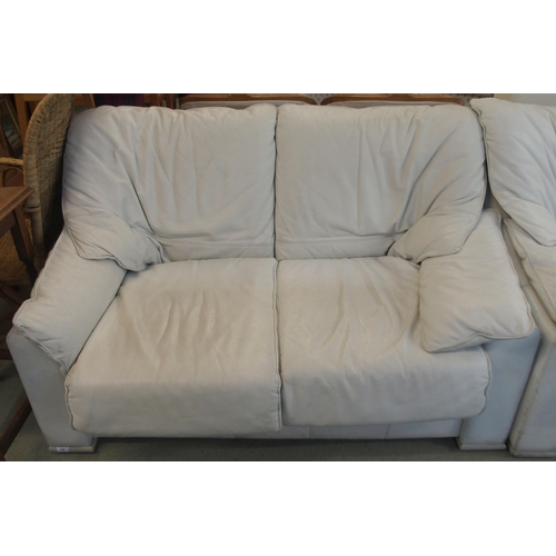 116 - A 20th century white leather upholstered two seater sofa, 85cm high x 140cm wide x 95cm deep