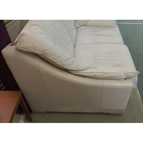 116 - A 20th century white leather upholstered two seater sofa, 85cm high x 140cm wide x 95cm deep