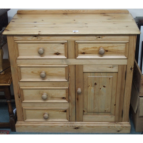 121 - A 20th century pine bedroom chest with two short drawers over three short drawers beside cabinet doo... 