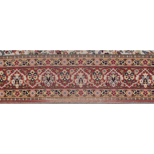 130 - A 20th century cream ground eastern style rug with all over design and dark red borders, 365cm long ... 