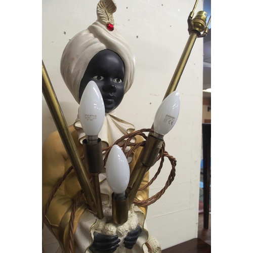 64 - A blackamoor style ceramic table lamp in the form of a boy in turban