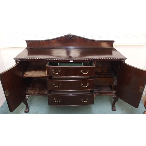 73 - A 20th century mahogany serpentine front sideboard with three central drawers flanked by cabinet doo... 