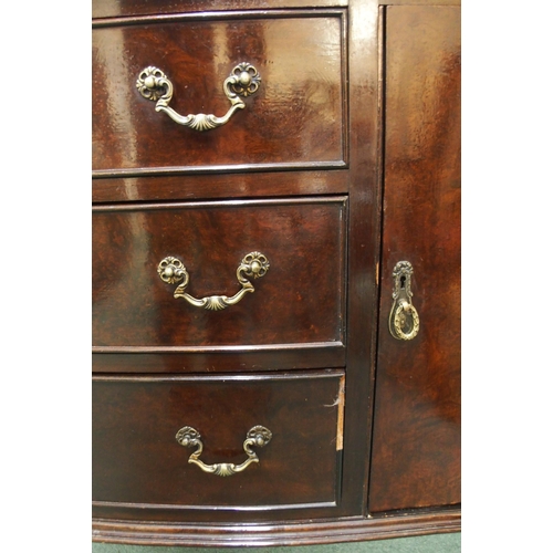 73 - A 20th century mahogany serpentine front sideboard with three central drawers flanked by cabinet doo... 