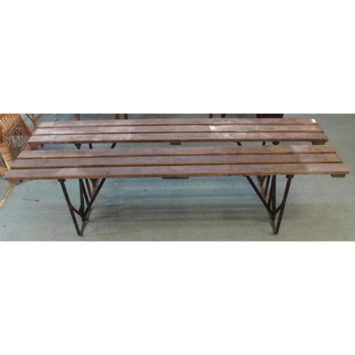 82 - A pair of 20th century wooden benches with iron folding supports, 50cm high x 181cm long x 24cm deep... 