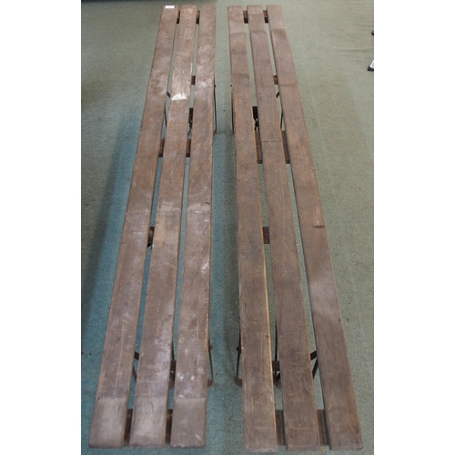 82 - A pair of 20th century wooden benches with iron folding supports, 50cm high x 181cm long x 24cm deep... 