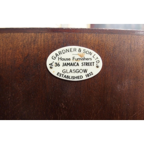 93 - An early 20th century mahogany Gardner & Son sideboard with three central drawers flanked by cab... 