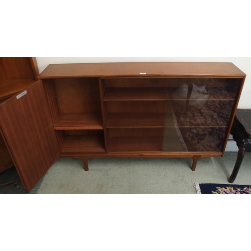 95 - A mid 20th century teak McIntosh of Kirkcaldy glazed sliding door bookcase, 88cm high x 136cm wide x... 