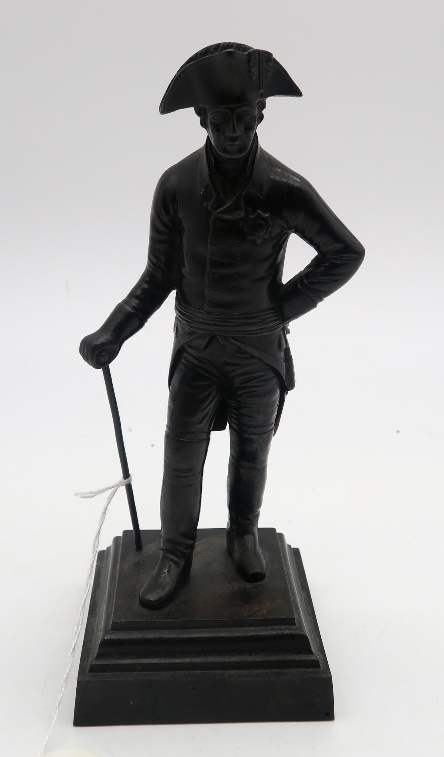 A small bronze statue of a Regency gentleman, wearing an Ord...