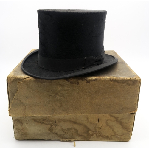 509 - A boxed silk top hat, of medium-large size (measures 20.5cm front to back and 16cm side to side)