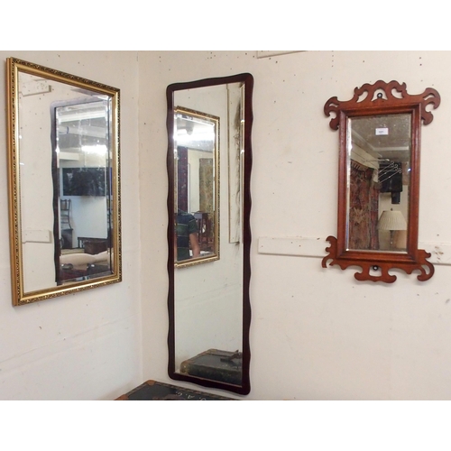 101 - A 20th century gilt framed bevelled glass wall mirror, a mahogany framed bevelled glass wall mirror ... 