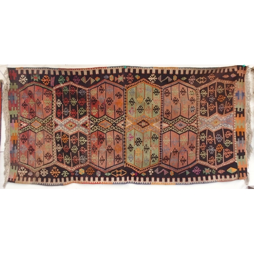 108 - A multicoloured ground Turkish Kilim rug with all over geometric design