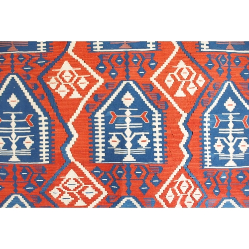 111 - A red ground Turkish tribal rug all over geometric design