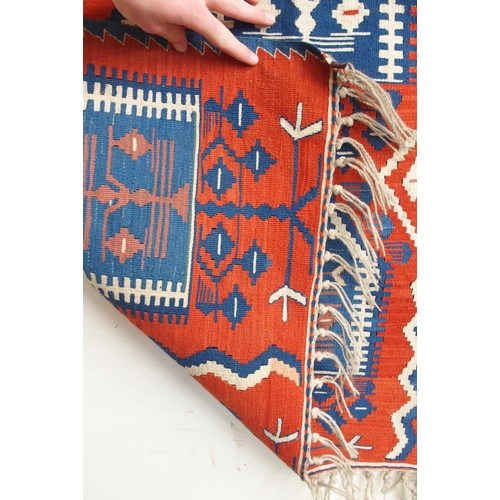 111 - A red ground Turkish tribal rug all over geometric design