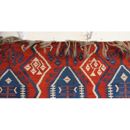 111 - A red ground Turkish tribal rug all over geometric design