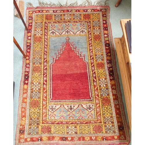 151 - A red ground Persian prayer rug with multicoloured border