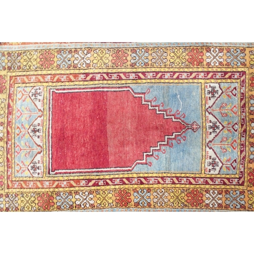 151 - A red ground Persian prayer rug with multicoloured border