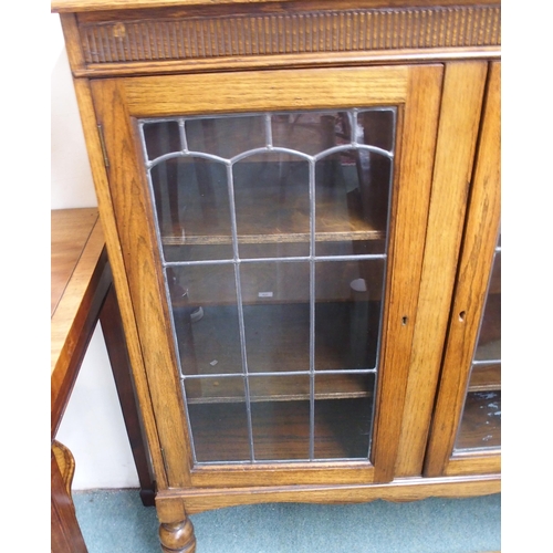 167 - A 20th century oak leaded glass bookcase and a mahogany occasional table (2)