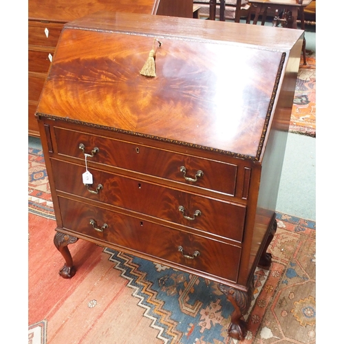 176 - A 20th century mahogany writing bureau with fitted fall front writing compartment over three drawers... 