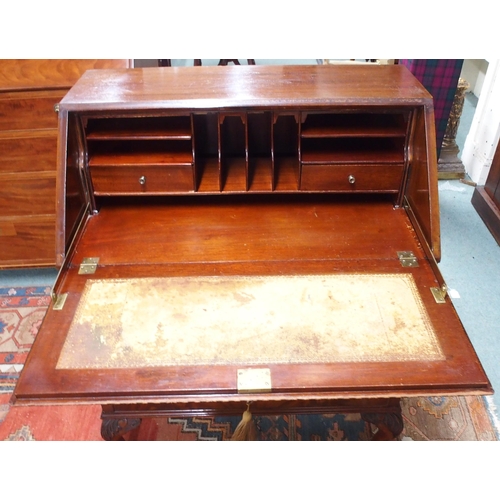 176 - A 20th century mahogany writing bureau with fitted fall front writing compartment over three drawers... 