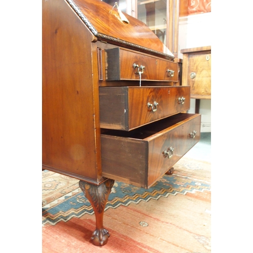 176 - A 20th century mahogany writing bureau with fitted fall front writing compartment over three drawers... 